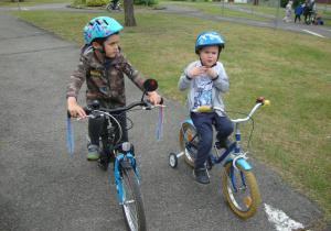 Chłopcy jadą rowerkami